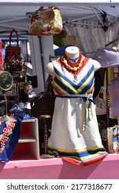 A Vibrant Outdoor Display Of A Vintage Clothing Pop Up Shop At A Festival