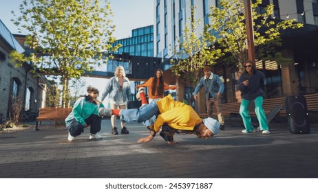 Vibrant Outdoor Scene Capturing A Diverse Group Of Young Adults Energetically Breakdancing In An Urban Setting, Surrounded By Modern Architecture And Greenery, Showcasing Youth, Culture, Friendship. - Powered by Shutterstock