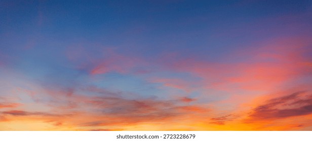 Vibrant Panoramic Sunset Sky with Dramatic Pink and Orange Clouds,A breathtaking panoramic view of a sunset sky featuring a vivid transition from deep blue to brilliant orange and pink hues,