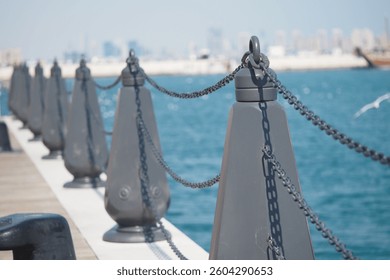 Vibrant pier view with chain-linked posts and clear waters