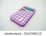 A vibrant purple calculator with pink buttons on a white background. The calculator displays numbers on its screen and features basic arithmetic functions, making it ideal for everyday calculations