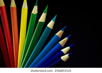 Vibrant rainbow colored pencils arranged in a fan shape on a black background. Arts supplies. Stationary supplies. Pride celebration. - Powered by Shutterstock