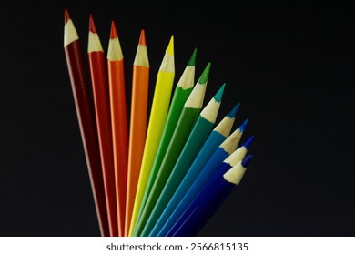 Vibrant rainbow colored pencils arranged in a fan shape on a black background. Arts supplies. Stationary supplies. Pride celebration. - Powered by Shutterstock