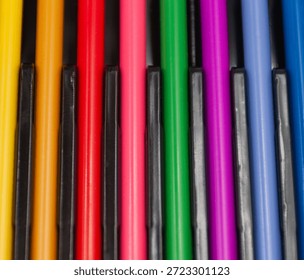 Vibrant rainbow markers in a close up array. Multi colored markers.