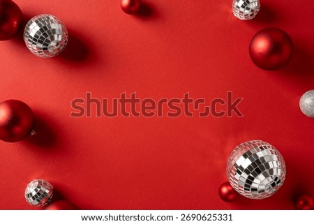 Vibrant red backdrop featuring mirrored disco balls and red ornaments, perfect for Christmas and New Year promotions, greeting cards, and seasonal product shoots with glamorous holiday flair