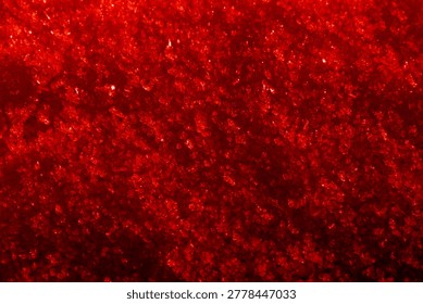A vibrant red colored image showcasing intricate frost crystals against a textured background, creating a mesmerizing visual effect perfect for abstract backgrounds or winter-themed designs.