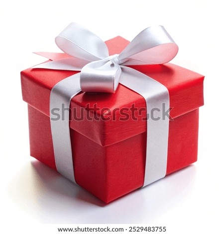 Vibrant red gift box featuring a crisp white satin ribbon bow tied on top captured with professional studio lighting on a clean white background for holiday celebrations or special birthday surprises during the festive winter season and throughout the year