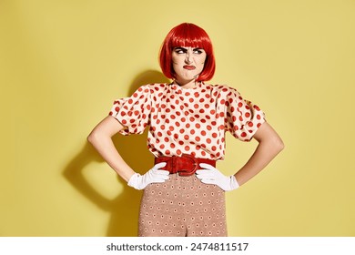 Vibrant red-haired woman with pop art makeup donning a polka dot blouse on a bold yellow backdrop. - Powered by Shutterstock