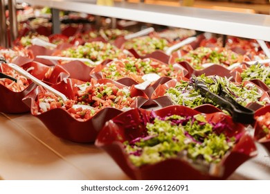 A vibrant salad bar is filled with an array of fresh vegetables and garnishes. The bowls showcase colorful ingredients, inviting guests to create their own healthy salads.