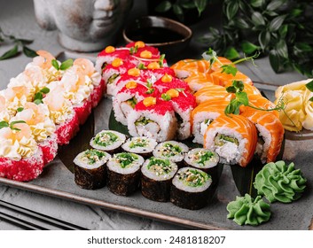 Vibrant selection of sushi presented with greenery, wasabi, and soy sauce on a sleek surface - Powered by Shutterstock