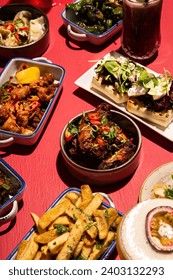 Vibrant Selection of Traditional and Modern Tapas Dishes on a Bright Pink Background - Stylishly Staged Photography Ideal for Trendy Modern Eateries