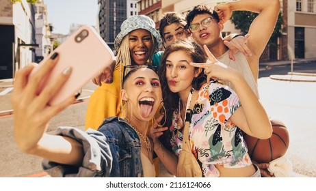 Vibrant Selfies. Group Of Multiethnic Young People Posing For A Selfie Together Outdoors. Cheerful Generation Z Friends Having Fun And Capturing Their Happy Moments In The City.