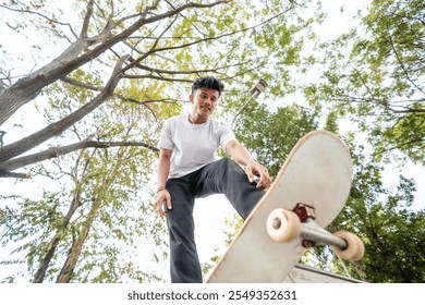 A vibrant shot of a skilled skateboarder performing tricks amidst lush greenery - Powered by Shutterstock