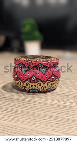 Vibrant small pot featuring traditional Pakistani truck art design, showcasing intricate patterns and bold colors. Perfect for adding a touch of cultural charm and artistic flair to any space.