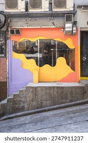 Vibrant storefront with orange and purple waves framing a glass entrance on a sloped street. Branding reads HEI RICE beside a green rice logo. Exterior vents and concrete steps suggest an urban neighborhood eatery. Bright colors communicate a casual rice shop or takeaway, ideal for lifestyle or retail features.