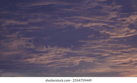 A vibrant sunset with shades of orange, pink, and purple lighting up the sky, silhouetting trees and rooftops, creating a serene and warm atmosphere. - Powered by Shutterstock