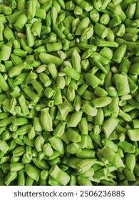 A vibrant texture of fresh green beans, showcasing their natural color and unique shape.
A kaleidoscope of green hues unfolds in this close-up image of sliced green beans.
