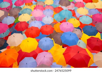 Vibrant Umbrella Canopy - A Kaleidoscope of Colors and Patterns Overhead. A display of countless colorful umbrellas creating a canopy overhead. Concepts, diversity, togetherness, and vibrancy. - Powered by Shutterstock