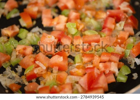 Vibrant veggie mixture. Quick nutritious vegetable stirfry with peppers and tomatoes. Healthy skilletcooked vegetable blend with peppers onions and diced tomatoes