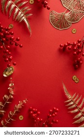 Vibrant vertical red background frames decorative gold leaves berries and coins celebrating Chinese New Year
