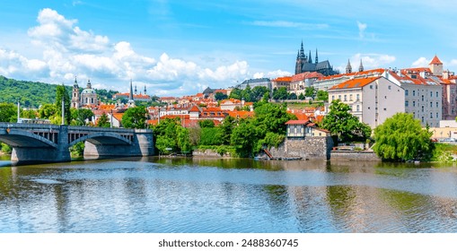 A vibrant view capturing the historic Prague Castle and Manes Bridge on a sunny day with clear skies, overlooking the calm Vltava River. - Powered by Shutterstock