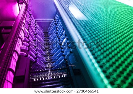 A vibrant view of a modern data center showcasing colorful cables, advanced equipment, and innovative technology, emphasizing networking and connections.