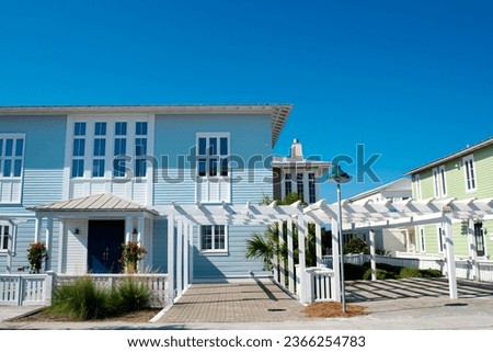 Vibrant white pergola, picket fence front yard curb appeal along scenic 30A country road in Santa Rosa, South Walton Beaches near Destin, Florida Panhandle. Residential vacation homes clear blue sky Stock photo © 
