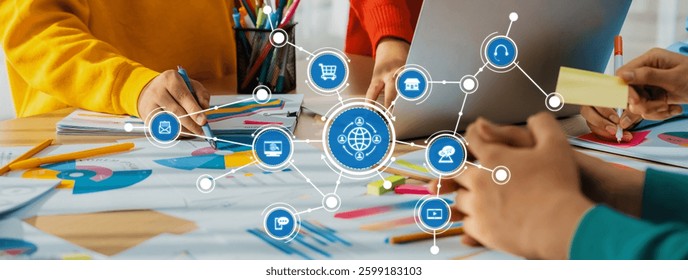A vibrant workspace featuring hands collaborating on projects with colorful stationery and a digital interface, showcasing teamwork and creativity in a modern office setting. Amity
