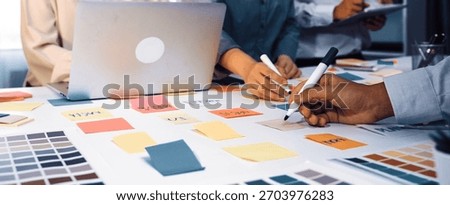 A vibrant workspace setup showcasing a team collaborating with color swatches and notes, highlighting creativity and ideation process for design concepts and project planning. SACTR