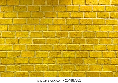 Vibrant yellow brick wall as a background