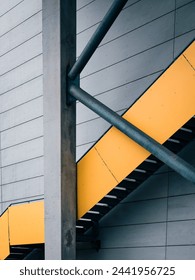 A vibrant yellow staircase stands next to a modern building in Gothenburg, Sweden. The staircase provides access to the building and adds a pop of color to the urban landscape.