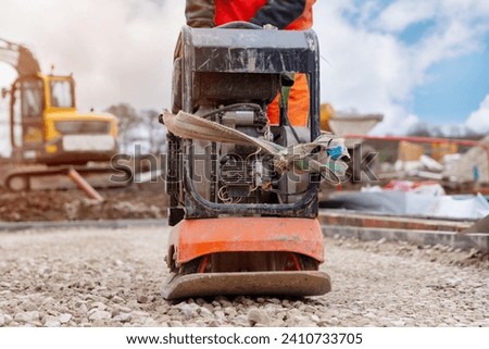 Vibrating plate compactor osed to compact ground and stone on building site