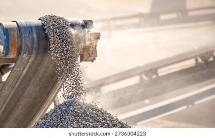 Vibrating screen stone crusher in operation. Crushing stones in a quarry for processing minerals, cement, limestone. Heavy and mobile equipment in a quarry for processing stone into building material.