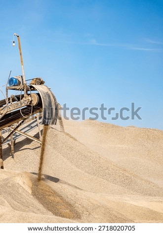 Vibrating screen stone crusher in operation. Crushing stones in a quarry for processing minerals, cement, limestone. Heavy and mobile equipment in a quarry for processing stone into building material.