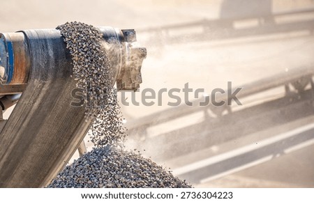 Vibrating screen stone crusher in operation. Crushing stones in a quarry for processing minerals, cement, limestone. Heavy and mobile equipment in a quarry for processing stone into building material.