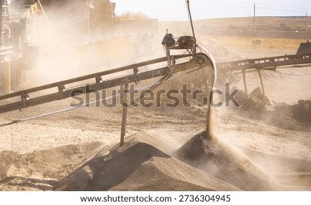 Vibrating screen stone crusher in operation. Crushing stones in a quarry for processing minerals, cement, limestone. Heavy and mobile equipment in a quarry for processing stone into building material.