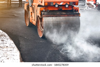 Vibration Roller Compactor Lay New Asphalt Surface In Wintertime. Road Construction, Asphalt Roller Press Hot Asphalt. Asphalt Paving, Steamroller Machine 