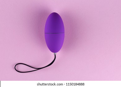 Vibrator egg sex toy for adult, design minimal dildo vibrator for clitoris isolated on pink background.