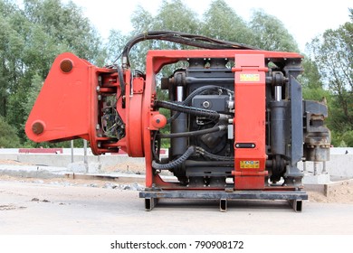 Vibrator pile driving Machine or vibro hammer stands on the site of construction of a major road junction. Russia.