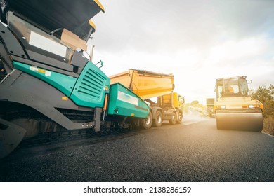 Vibratory asphalt rollers compactor compacting new asphalt pavement. Road service repairs the highway