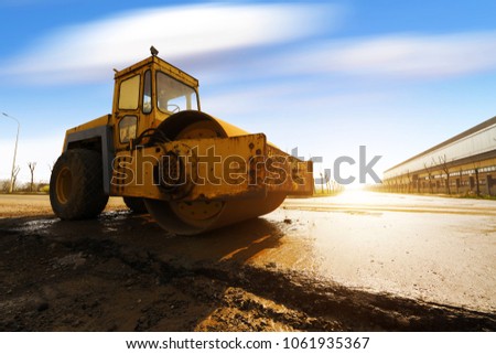 Vibratory soil compactor working on highway construction site