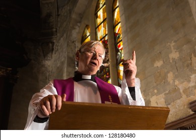 Vicar talking on his pulpit in a 17th century old church - Shutterstock ID 128180480