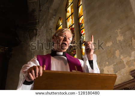 Vicar talking on his pulpit in a 17th century old church
