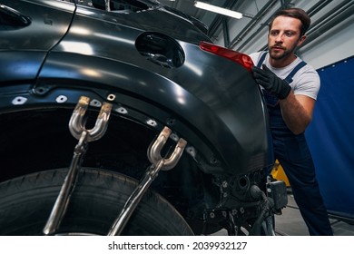 Vice Grips Locked To Car Frame While Mechanic Inspecting Taillight