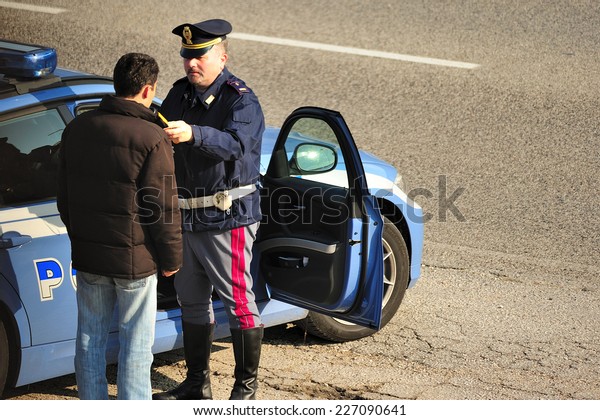 Vicenza,\
Northern Italy, Italy - October, 29, 2011: Italian police make an\
alcohol test to a motorist stopped for a\
control