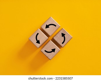 Vicious circle in business or life concept. Routine, comfort zone and inertia in everyday procedures and processes. Arrows forming a circle on wooden cubes. - Shutterstock ID 2231585507
