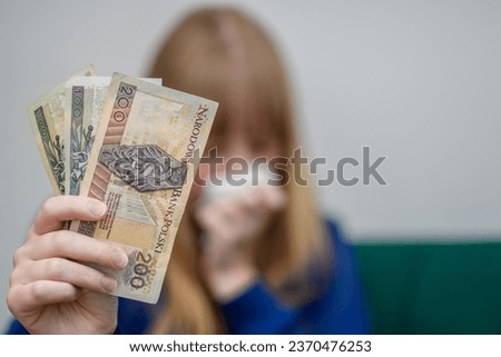 A victim of financial fraud holds Polish banknotes in his hands