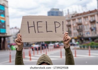 Victim In Need Of Help. Request For Support. Sacrifice. Social Public Messages On Banners Outside On Streets. Problems Reflection Phrases . Man Holding Conceptual Sign. Guy With Sign Inspiration