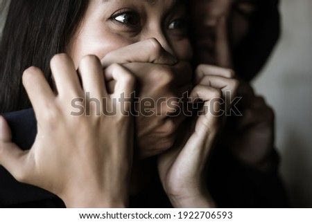 Victim young woman get shock and terrified when bad guy use hand close her mouth for stop scream Dangerous man want to abducted her for ransom Kidnap asian girl is one of victim of human trafficking