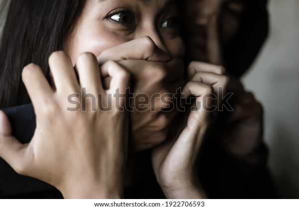 Victim young woman get shock and terrified\
when bad guy use hand close her mouth for stop scream Dangerous man\
want to abducted her for ransom Kidnap asian girl is one of victim\
of human trafficking